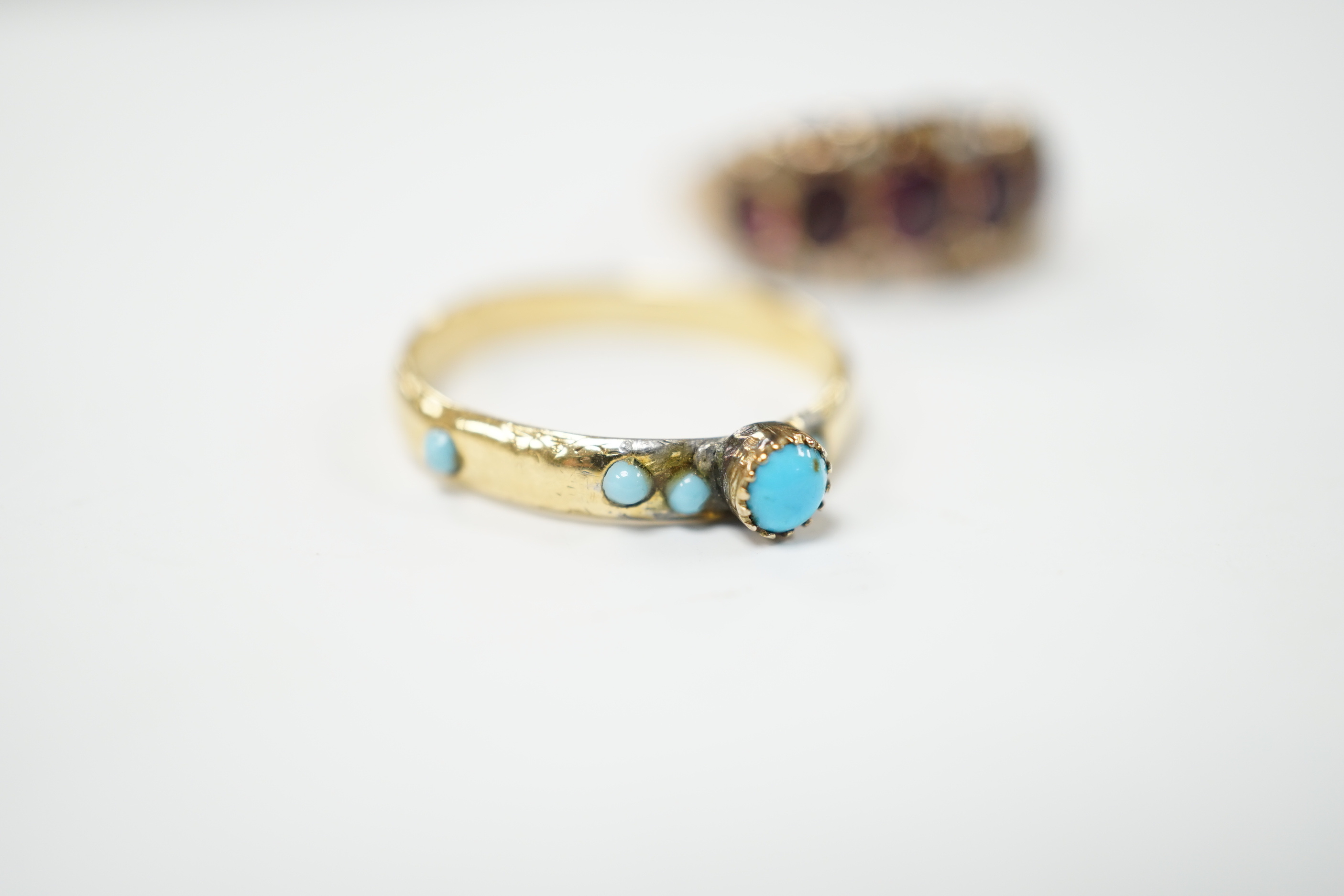 A Victorian garnet and seed pearl dress ring, size O, and a turquoise set yellow dress ring, size K